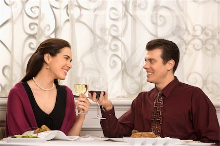simsearch:400-05357363,k - Mid adult Caucasian couple smiling and toasting wine glasses in restaurant. Photographie de stock - Aubaine LD & Abonnement, Code: 400-03926553