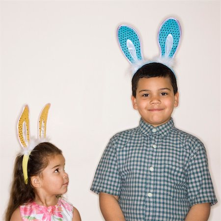 simsearch:400-04452450,k - Hispanic girl looking up at Hispanic boy both wearing bunny ears. Stock Photo - Budget Royalty-Free & Subscription, Code: 400-03926560