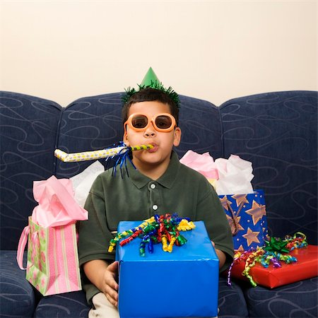 simsearch:400-04452450,k - Hispanic boy with birthday party favors and presents looking at viewer. Stock Photo - Budget Royalty-Free & Subscription, Code: 400-03926563