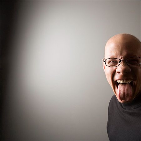 Portrait of mid-adult Caucasian male sticking out tongue. Stock Photo - Budget Royalty-Free & Subscription, Code: 400-03926837