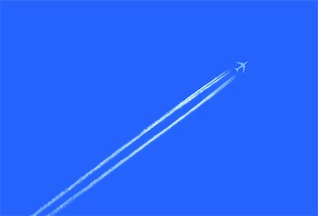Airplane in the sky with  jet trail Stock Photo - Budget Royalty-Free & Subscription, Code: 400-03927030