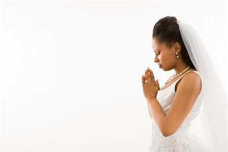 Mid-adult African-American bride praying  with white background. Stock Photo - Budget Royalty-Free & Subscription, Code: 400-03927192