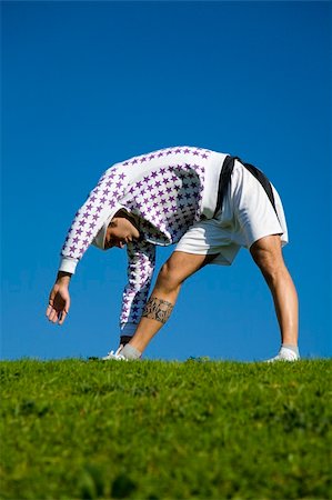 simsearch:400-04450996,k - healthy lifestyle: man doing stretching in a park Stock Photo - Budget Royalty-Free & Subscription, Code: 400-03927272