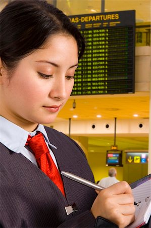 businesswoman writing a report in an airport departure area. Stock Photo - Budget Royalty-Free & Subscription, Code: 400-03927306