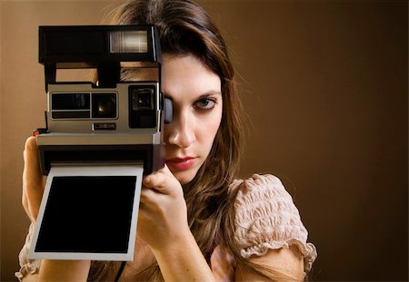 stylish woman snapshot - old-fashioned: girl taking a picture with an old polaroid Stock Photo - Budget Royalty-Free & Subscription, Code: 400-03927894