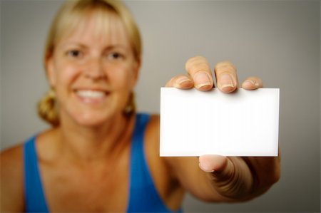 simsearch:400-04648812,k - Smiling Woman Holding Blank Business Card. Room for text, or your own message. Stock Photo - Budget Royalty-Free & Subscription, Code: 400-03927931