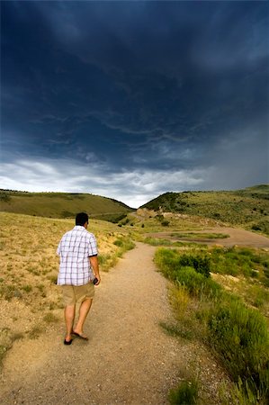 simsearch:400-08750812,k - Hiker walking in to the storm Stock Photo - Budget Royalty-Free & Subscription, Code: 400-03928047