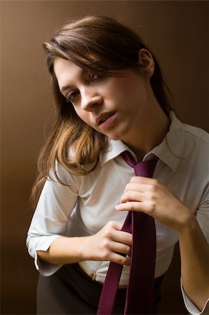 simsearch:400-07681479,k - women at work: irritated businesswoman fixing her tie Stock Photo - Budget Royalty-Free & Subscription, Code: 400-03928117