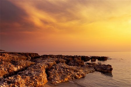 Image shows a rock formation under a spectacular sunset sky. Stock Photo - Budget Royalty-Free & Subscription, Code: 400-03928171