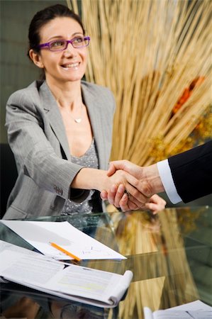 smiling lawyers shaking hands in office - People at work: man and woman hand shaking at a meeting Stock Photo - Budget Royalty-Free & Subscription, Code: 400-03928228