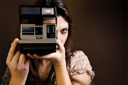 stylish woman snapshot - old-fashioned: girl taking a picture with an old polaroid Stock Photo - Budget Royalty-Free & Subscription, Code: 400-03928293