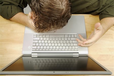 simsearch:400-09030070,k - Frustrated businessman shows his frustration while working on his laptop. Fotografie stock - Microstock e Abbonamento, Codice: 400-03928446
