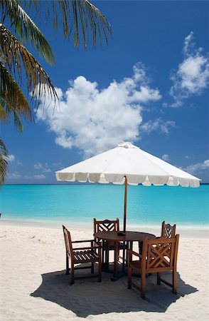 dining place with wooden chairs, table and white sun shade in a cafe on an maldivan island in the Indian Ocean Stock Photo - Budget Royalty-Free & Subscription, Code: 400-03928468