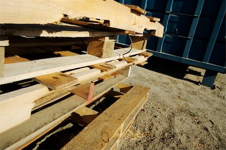 simsearch:632-03500555,k - Abstract Stack of Wooden Palettes with Dumpster in the background. Photographie de stock - Aubaine LD & Abonnement, Code: 400-03928542