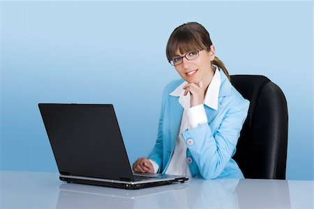 simsearch:400-08554629,k - Satisfied businesswoman working with a laptop on a blue background Fotografie stock - Microstock e Abbonamento, Codice: 400-03928590