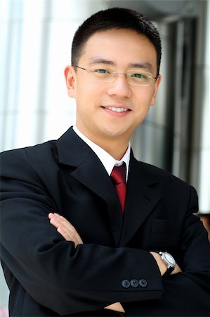simsearch:400-03926780,k - Good looking asian business man standing with arms folded. Stockbilder - Microstock & Abonnement, Bildnummer: 400-03928606