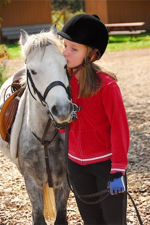 Portrait of a young girl with a white pony Foto de stock - Super Valor sin royalties y Suscripción, Código: 400-03928843