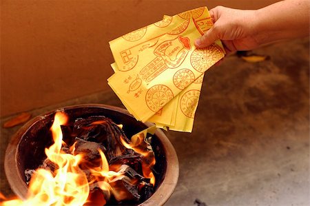 A typical burning fake money and gold for ancestors during Chinese Hungry Ghost Festival Stock Photo - Budget Royalty-Free & Subscription, Code: 400-03929014