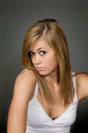 simsearch:400-04960190,k - Teenage girl posing on gray background with some attitude Stock Photo - Budget Royalty-Free & Subscription, Code: 400-03929639