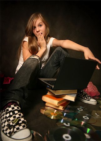 The young girl among books with a computer Stock Photo - Budget Royalty-Free & Subscription, Code: 400-03929796