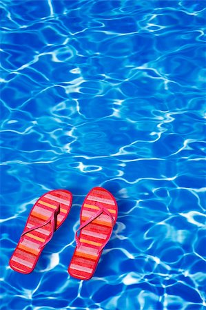 simsearch:400-05240428,k - Bright blue pool water background with floating sandals Photographie de stock - Aubaine LD & Abonnement, Code: 400-03920422