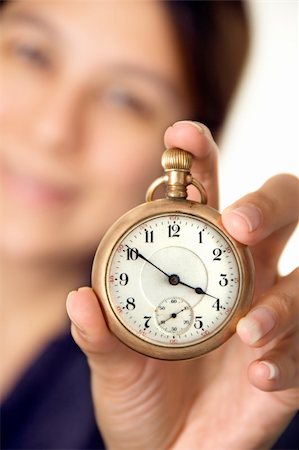 simsearch:700-03660003,k - Woman holding up a pocket watch - focus on watch Stock Photo - Budget Royalty-Free & Subscription, Code: 400-03920815