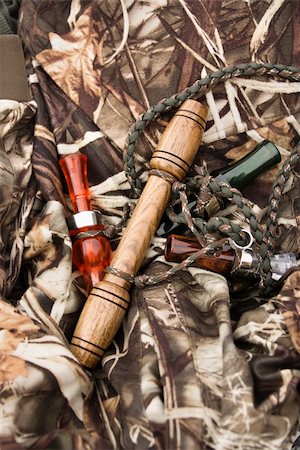 Still life shot of bird calls against camouflage clothing. Photographie de stock - Aubaine LD & Abonnement, Code: 400-03920900