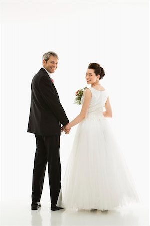 simsearch:400-04950359,k - Portrait of Caucasian groom and Asian bride holding hands. Stock Photo - Budget Royalty-Free & Subscription, Code: 400-03921044