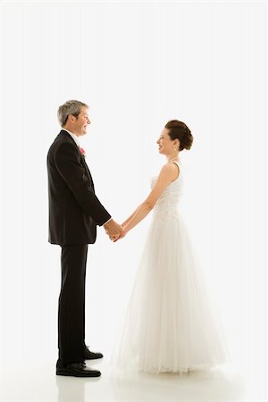 simsearch:400-04950359,k - Portrait of Caucasian groom and Asian bride holding hands. Stock Photo - Budget Royalty-Free & Subscription, Code: 400-03921047