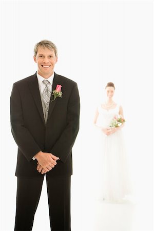 simsearch:400-04950359,k - Caucasian groom in foreground and Asian bride in background. Stock Photo - Budget Royalty-Free & Subscription, Code: 400-03921053