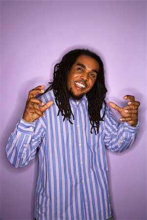 rastafarian - Smiling African-American mid-adult man on purple background with hands gesturing. Stock Photo - Budget Royalty-Free & Subscription, Code: 400-03921106