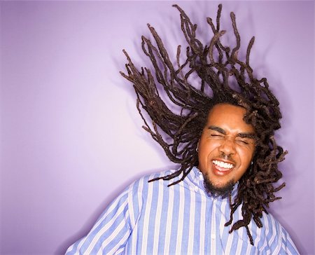 rastafarian - African-American mid-adult man on purple background with his dreadlocks in motion. Stock Photo - Budget Royalty-Free & Subscription, Code: 400-03921107