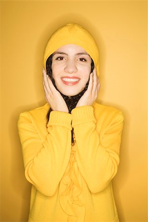 raincoat hood - Smiling young Caucasian woman wearing yellow raincoat on yellow background. Stock Photo - Budget Royalty-Free & Subscription, Code: 400-03921124