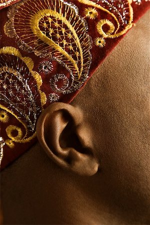 Close-up side view of African-American mid-adult man wearing traditional African hat. Stock Photo - Budget Royalty-Free & Subscription, Code: 400-03921214