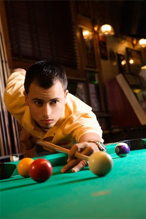 simsearch:400-03921226,k - Young man concentrating while aiming at pool ball while playing billiards. Stock Photo - Budget Royalty-Free & Subscription, Code: 400-03921232