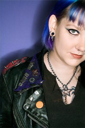 Portrait of Caucasian woman with blue hair and black leather jacket against blue background. Stock Photo - Budget Royalty-Free & Subscription, Code: 400-03921897