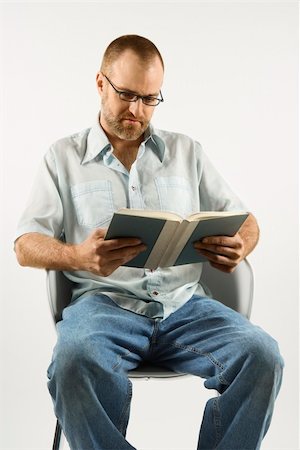 simsearch:400-03926822,k - Caucasian man sitting in chair reading book against white background. Stock Photo - Budget Royalty-Free & Subscription, Code: 400-03921913