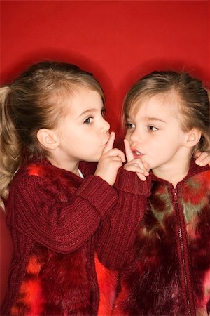 Female children Caucasian twins with fingers up to lips. Stock Photo - Budget Royalty-Free & Subscription, Code: 400-03922792