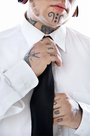 simsearch:400-03923064,k - Caucasian mid-adult man with tattoos and piercings adjusting necktie. Stock Photo - Budget Royalty-Free & Subscription, Code: 400-03923066