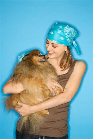 simsearch:400-04446240,k - Caucasian teen female holding Pomeranian dog. Foto de stock - Super Valor sin royalties y Suscripción, Código: 400-03923075