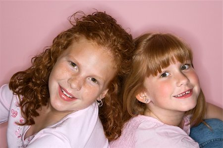 simsearch:400-03923096,k - Caucasian female children sitting back to back. Stock Photo - Budget Royalty-Free & Subscription, Code: 400-03923095
