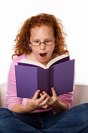 simsearch:400-03923096,k - Caucasian female child sitting reading book looking surprised. Stock Photo - Budget Royalty-Free & Subscription, Code: 400-03923097