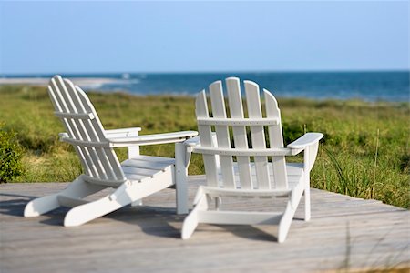 simsearch:400-03923118,k - Adirondack chairs on deck looking towards beach on Bald Head Island, North Carolina. Fotografie stock - Microstock e Abbonamento, Codice: 400-03923120