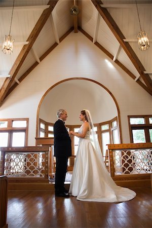 Protrait of bride and groom holding hands at the alter of a church. Stock Photo - Budget Royalty-Free & Subscription, Code: 400-03923516