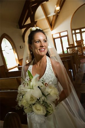 simsearch:400-04950359,k - Portrait of mid-adult bride holding bouquet leaving a church. Stock Photo - Budget Royalty-Free & Subscription, Code: 400-03923517