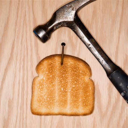 simsearch:640-02950998,k - Slice of toast nailed to wood with hammer. Stock Photo - Budget Royalty-Free & Subscription, Code: 400-03923627