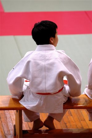A karate kid sitting on bench and watching the competition Stock Photo - Budget Royalty-Free & Subscription, Code: 400-03934029