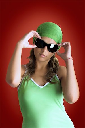 simsearch:400-03965656,k - Beautiful woman portrait in a red background with a green handkerchiefs Photographie de stock - Aubaine LD & Abonnement, Code: 400-03934234