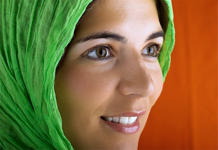 simsearch:400-03965656,k - Beautiful woman portrait in a red background with a green handkerchiefs Photographie de stock - Aubaine LD & Abonnement, Code: 400-03934233