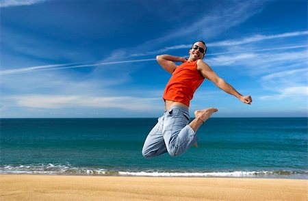 simsearch:400-06077546,k - Man jumping on a the beach with a beautiful cloudy sky Stockbilder - Microstock & Abonnement, Bildnummer: 400-03934252